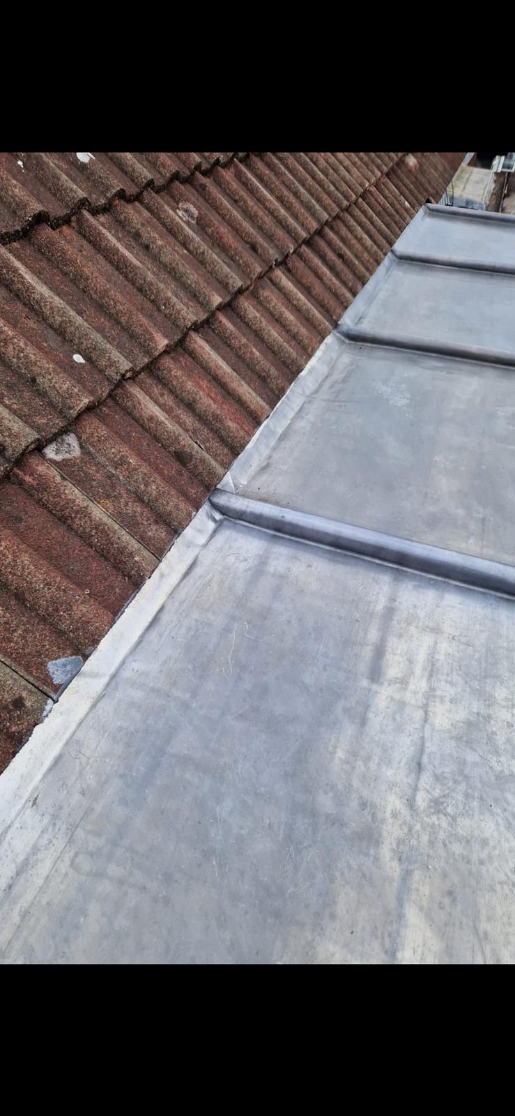 Lead valley detail between tiled and flat roof sections