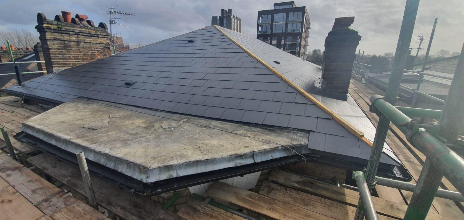 Completed slate hip roof with lead flashing and chimney detail
